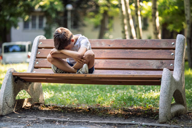 Abused child isolated in park
