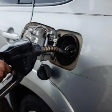 Man selling fuel into car