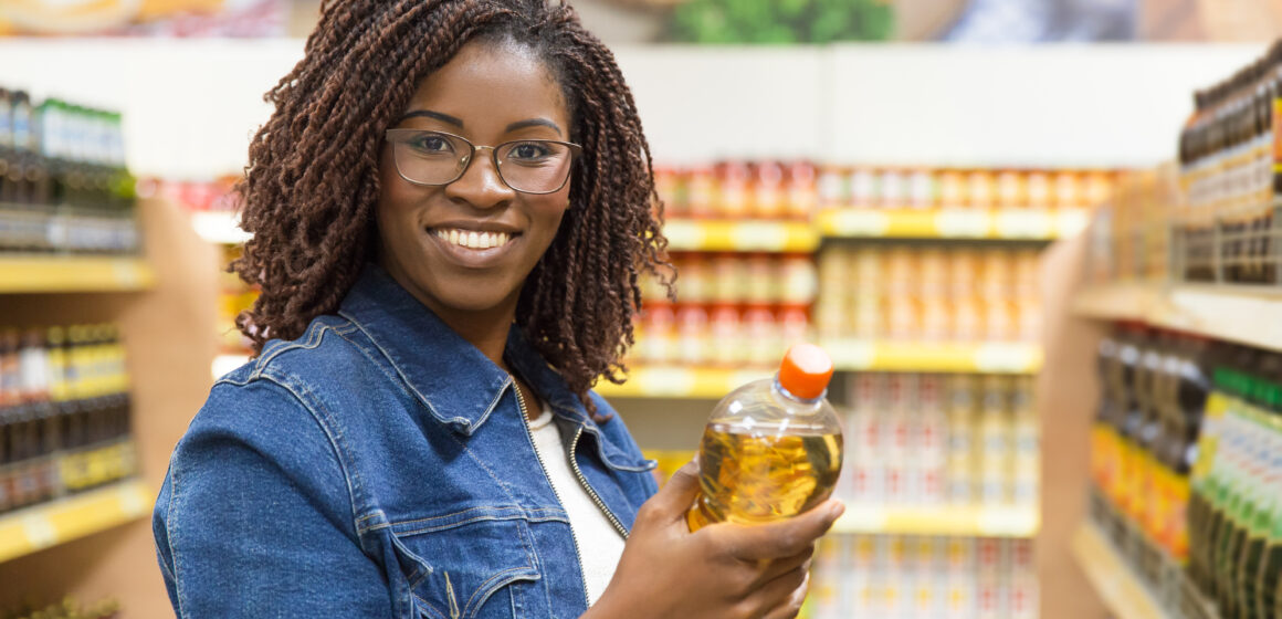 Young woman holding a bottle of oil