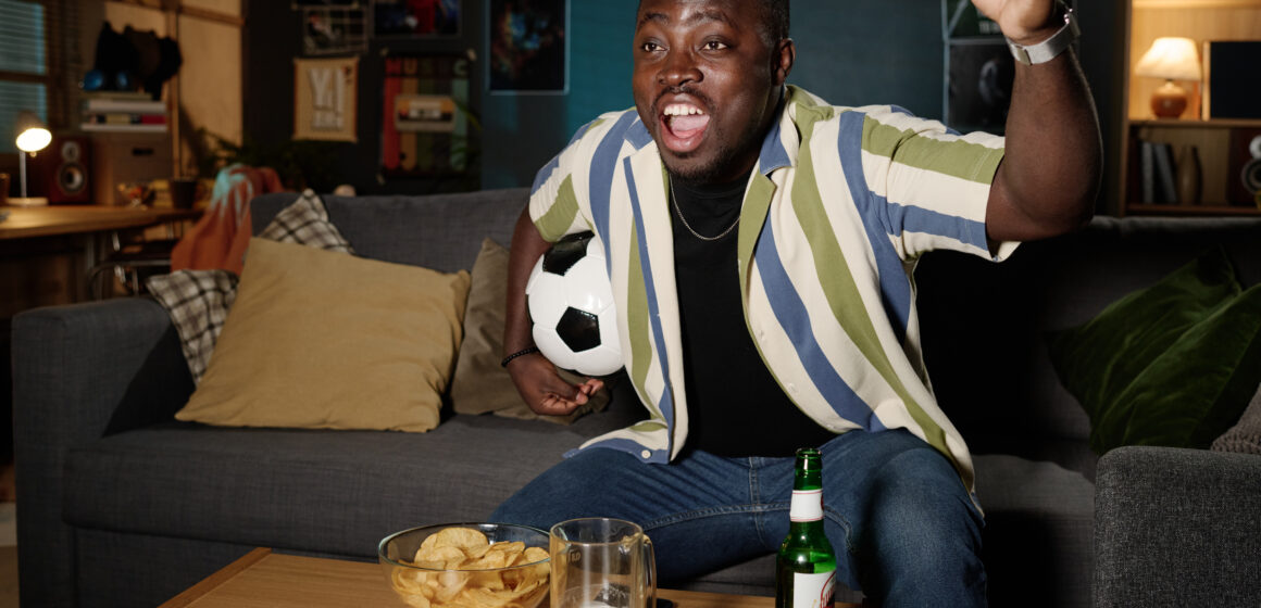 a man engaging in sports betting in Nigeria